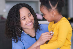Female pediatrician with patient