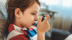 boy inhaling asthma inhaler